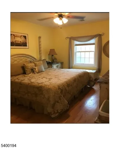 a bedroom with a bed dresser and a window