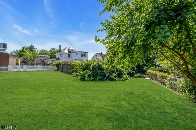 a view of a garden with a building in the background