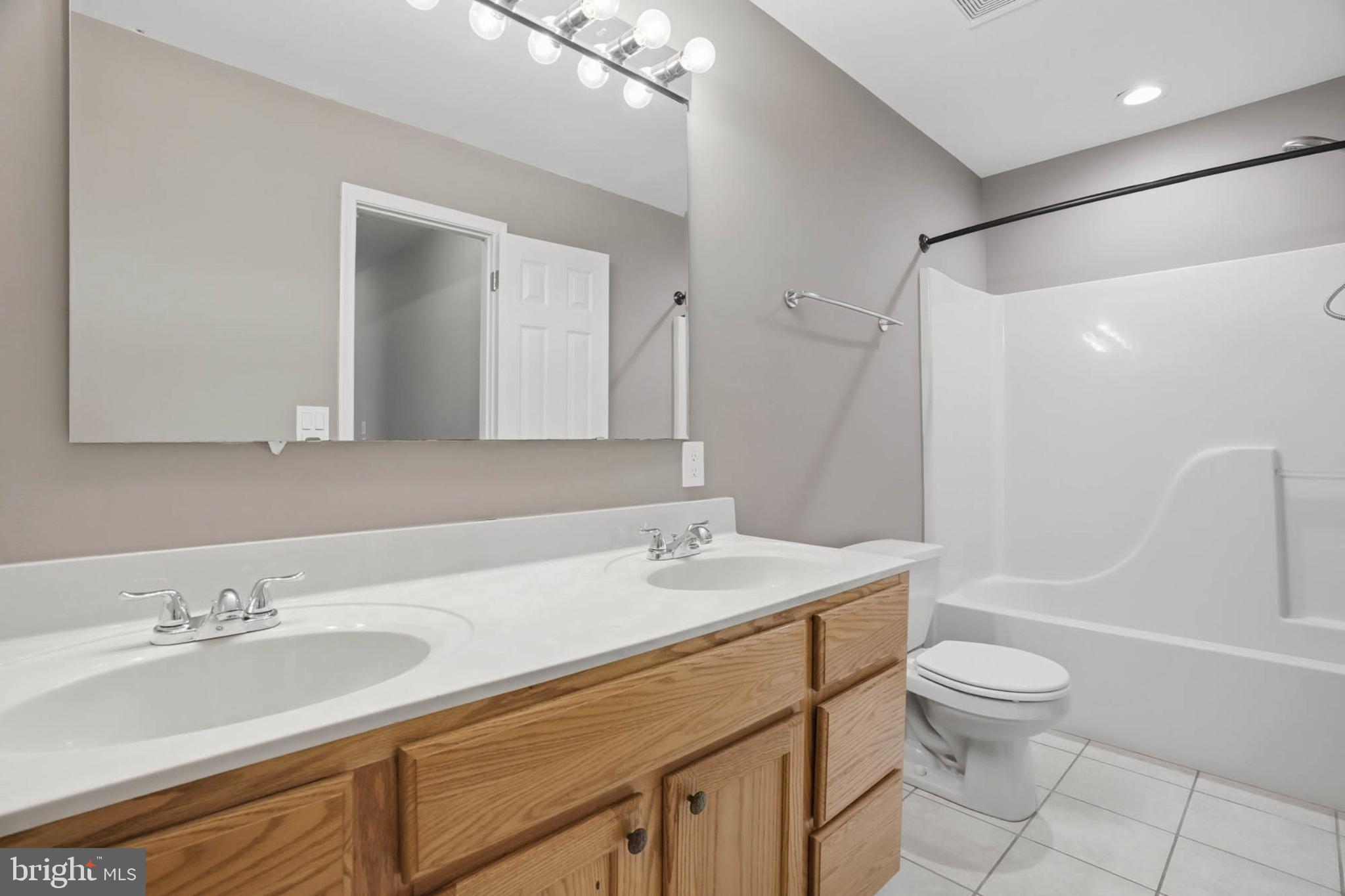 4742 Chestnut Road Shady Side, MD 20764 - Photo 25 of 41 Modern bathroom with dual sinks and tub.