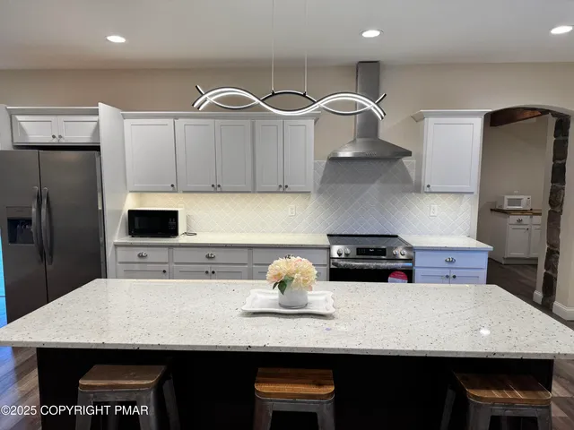 a kitchen with a stove a refrigerator and a stove