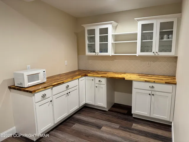 a kitchen with granite countertop white cabinets and white appliances