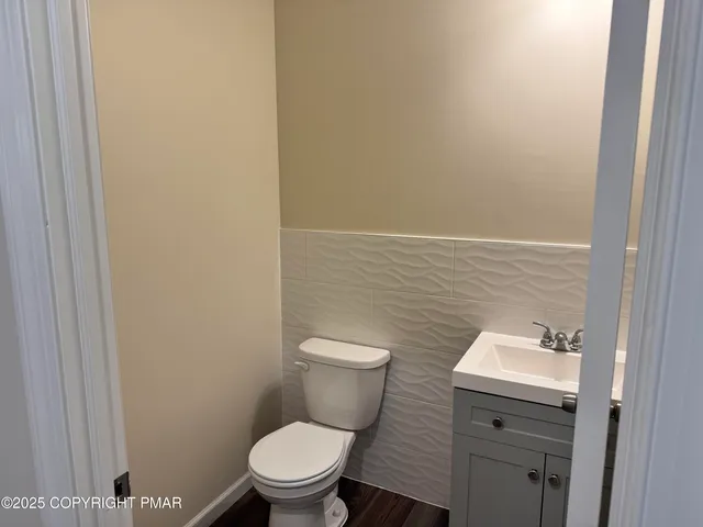 a white toilet sitting next to a bathroom sink