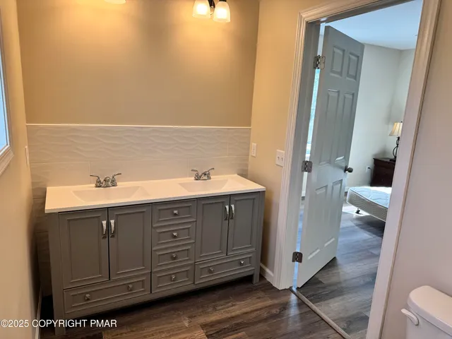 a spacious bathroom with a double vanity sink and mirror