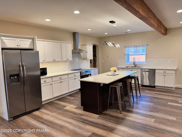 a kitchen with a table chairs refrigerator and microwave