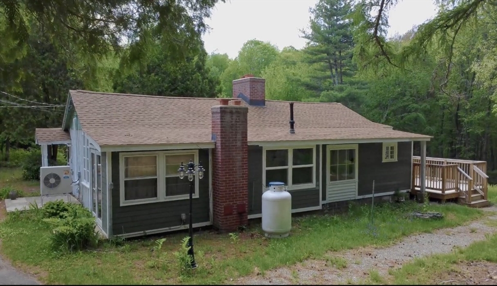 32 Hollow Road Wales, MA 01081 - Photo 2 of 35 a front view of a house with a garden and plants