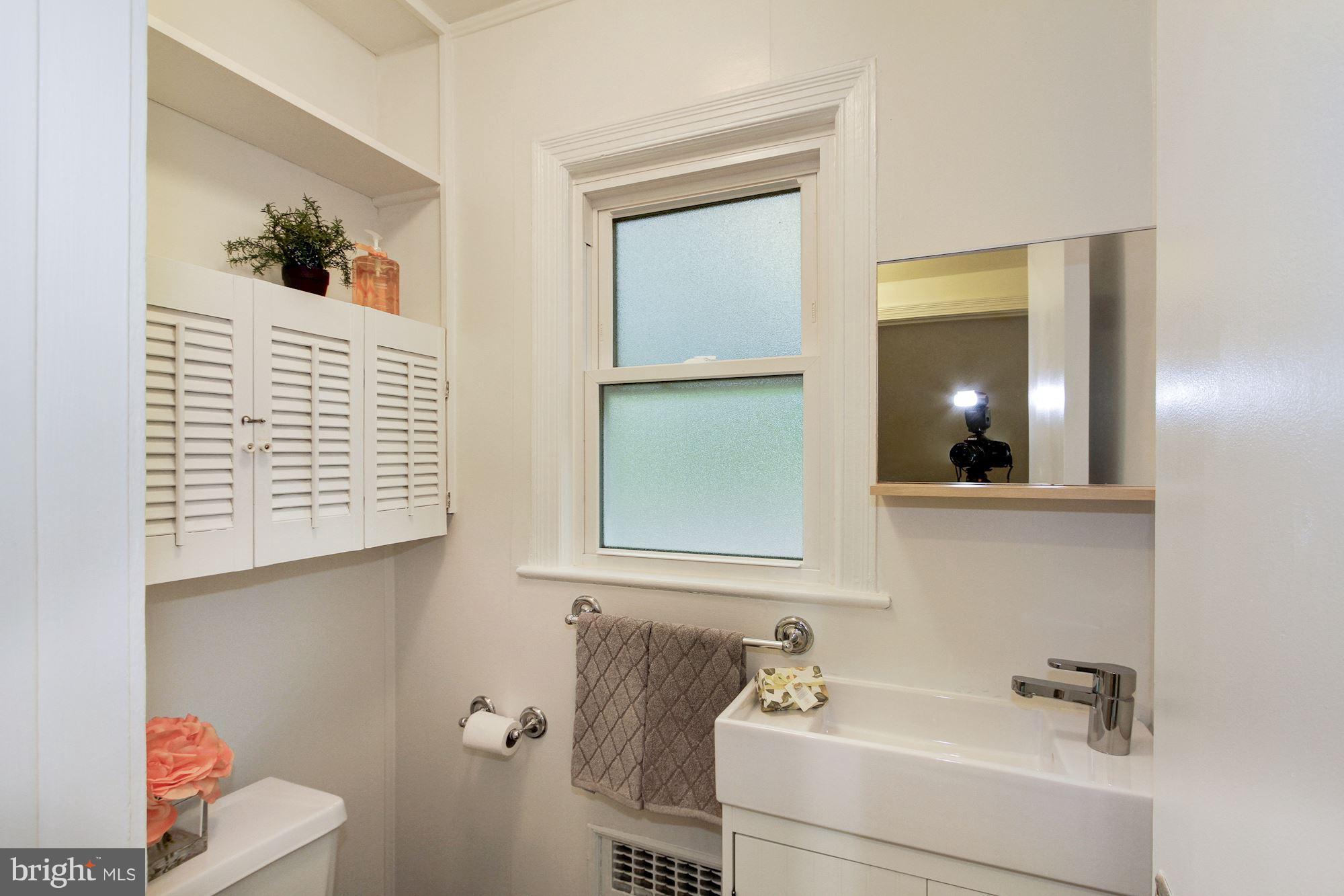 102 Wayne Avenue Silver Spring, MD 20901 - Photo 16 of 29 a bathroom with a sink and a mirror