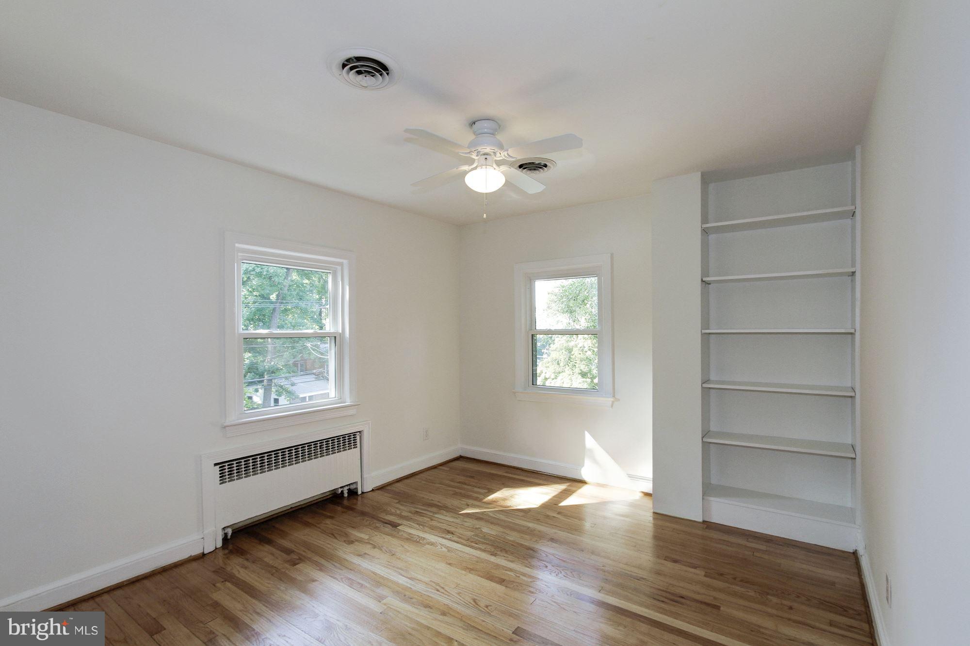 102 Wayne Avenue Silver Spring, MD 20901 - Photo 22 of 29 a view of empty room with wooden floor and fan