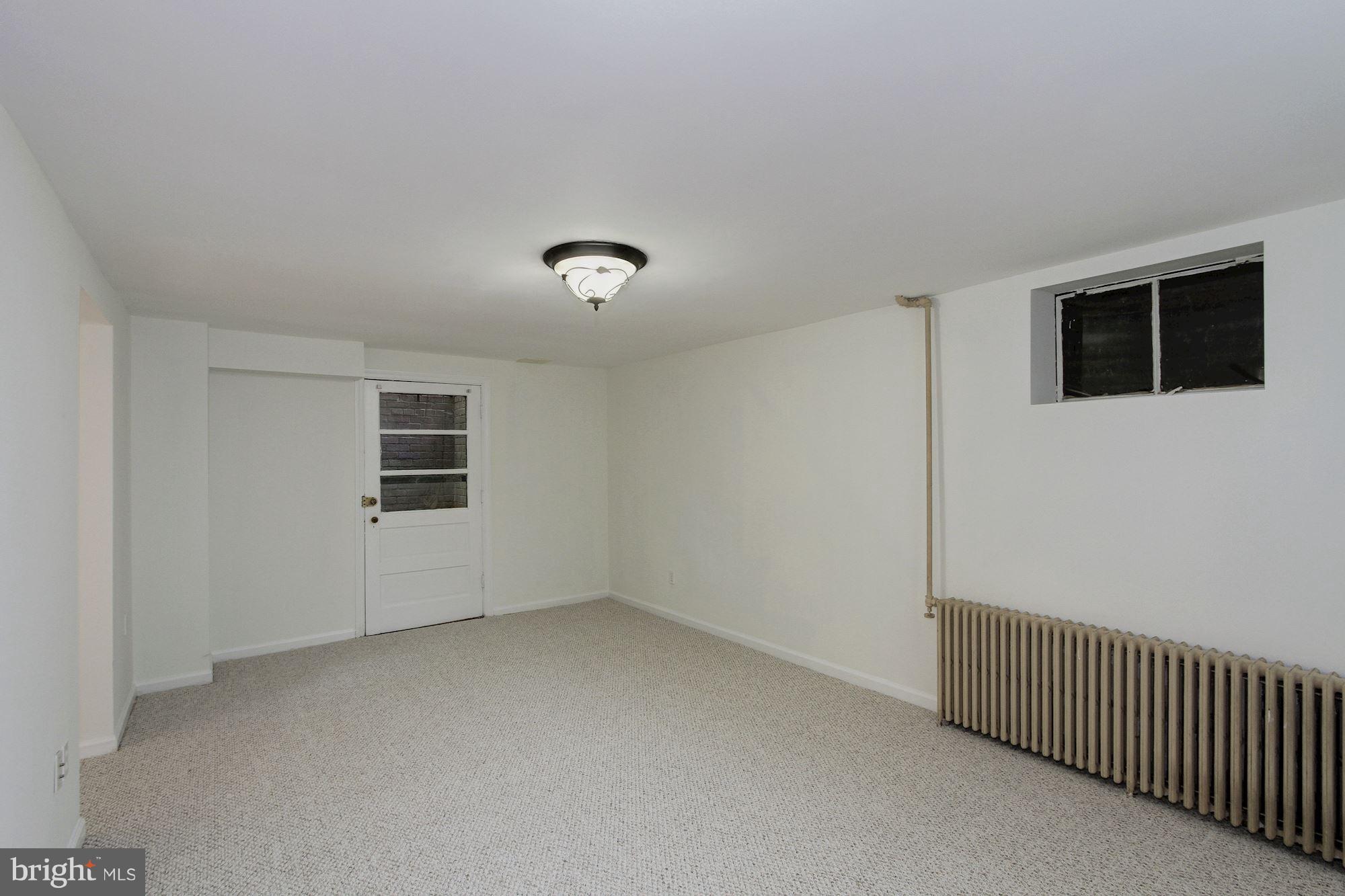 102 Wayne Avenue Silver Spring, MD 20901 - Photo 24 of 29 a view of a livingroom with an empty space & a window