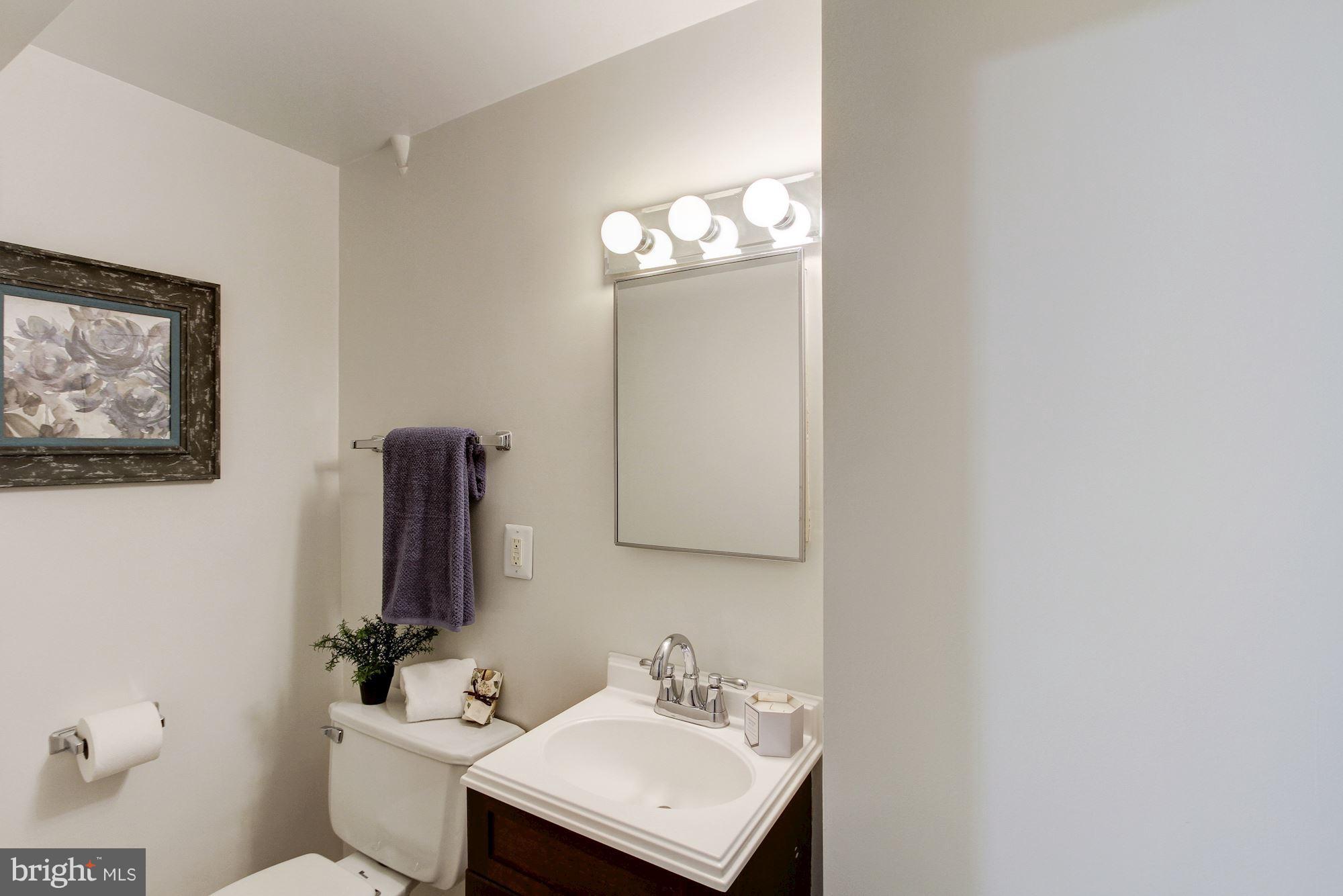 102 Wayne Avenue Silver Spring, MD 20901 - Photo 26 of 29 a bathroom with a sink toilet and mirror