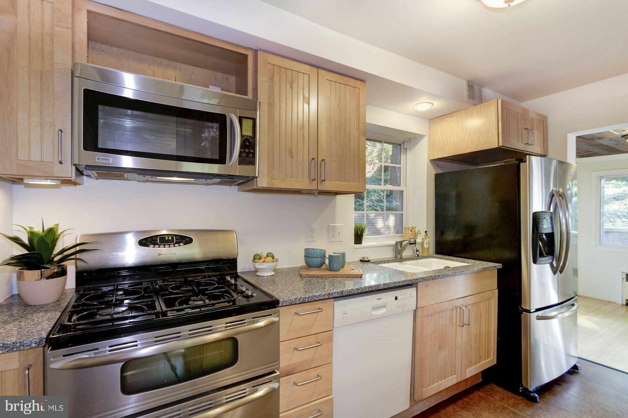 102 Wayne Avenue Silver Spring, MD 20901 - Photo 4 of 29 a kitchen with stainless steel appliances a stove a microwave and a sink