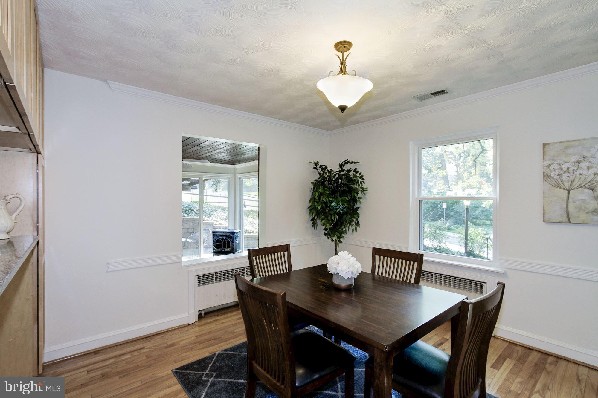 102 Wayne Avenue Silver Spring, MD 20901 - Photo 5 of 29 a view of a dining room with furniture window and wooden floor