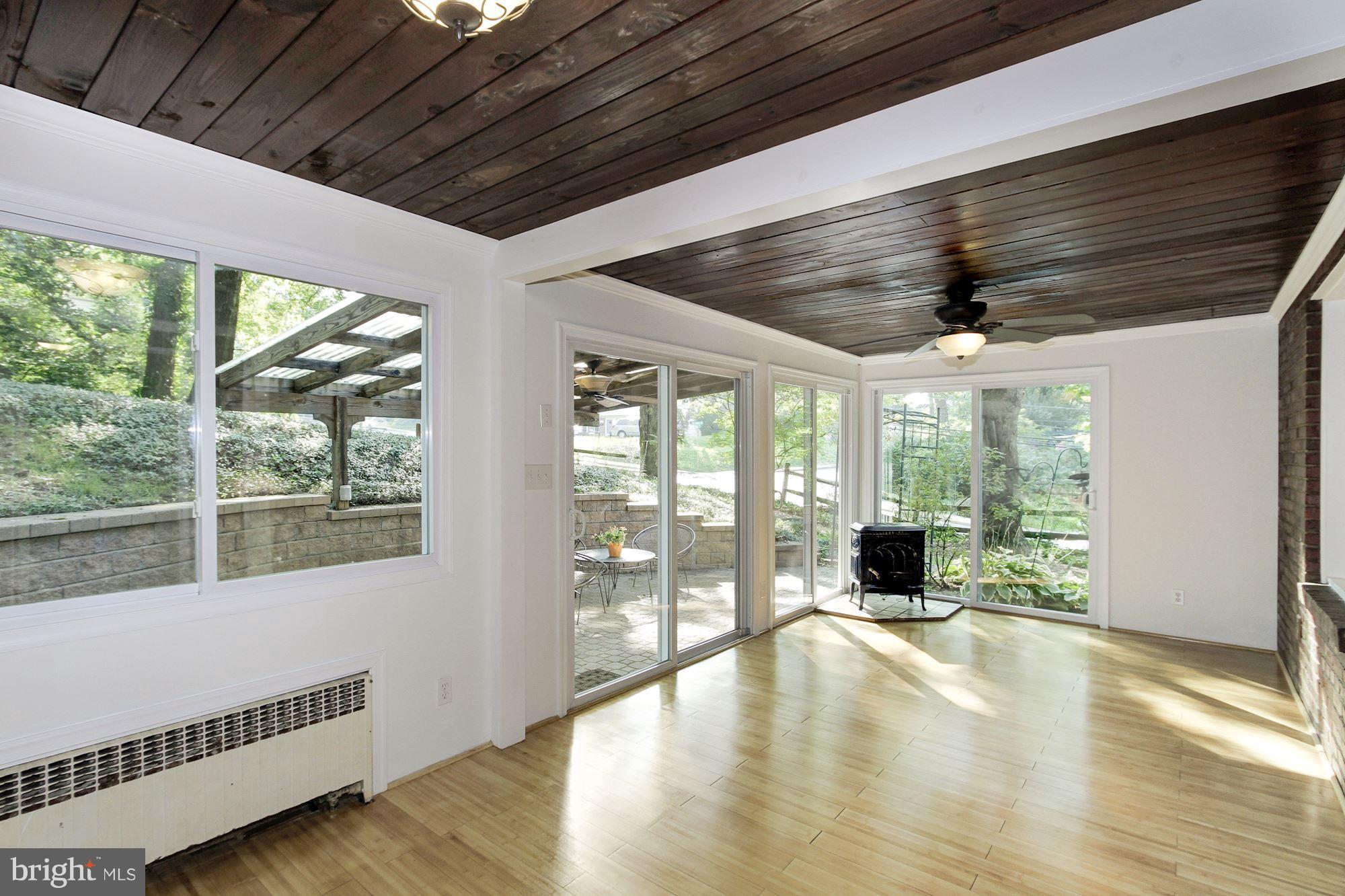 102 Wayne Avenue Silver Spring, MD 20901 - Photo 6 of 29 a view of an empty room with wooden floor and a window