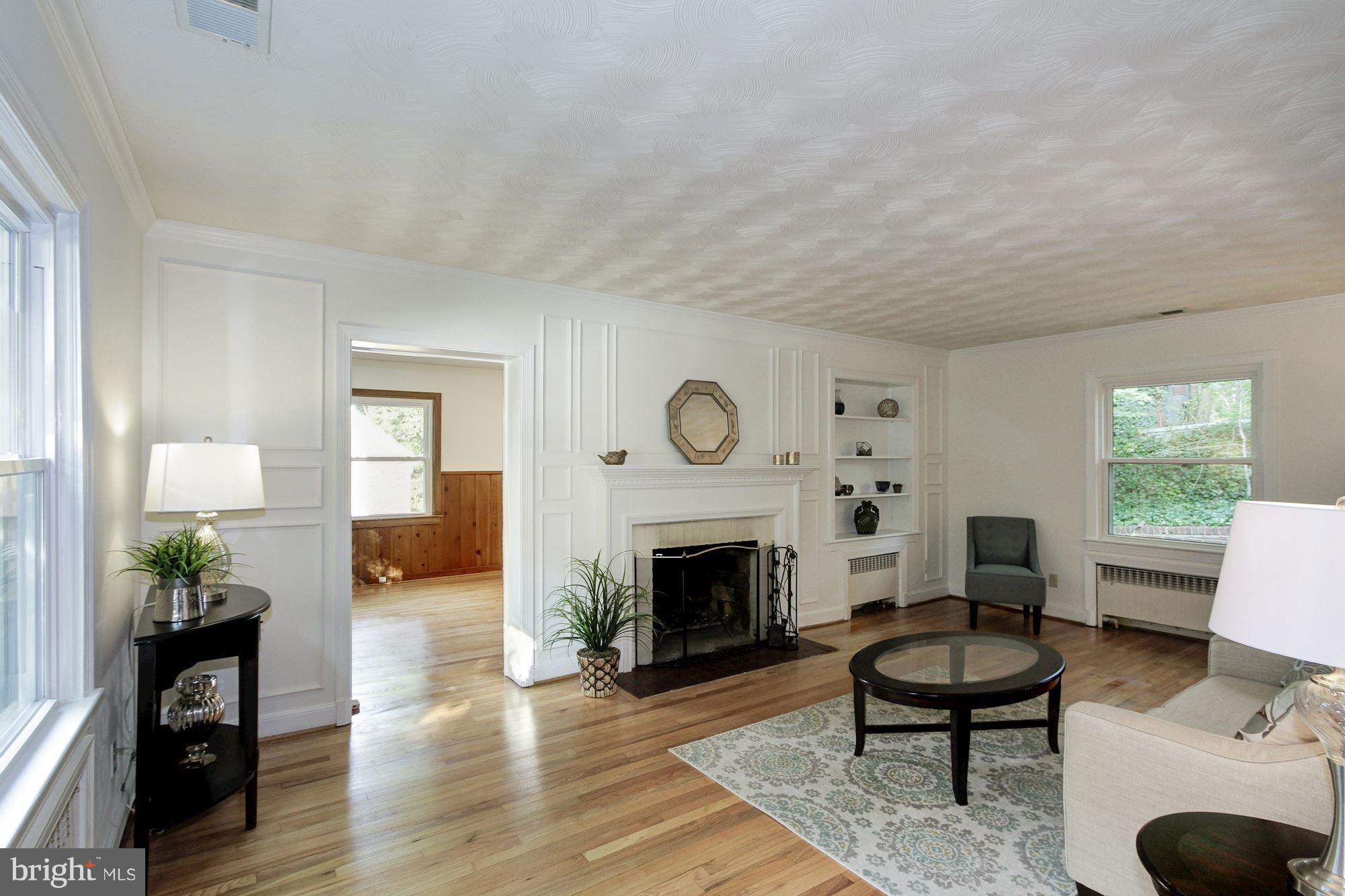 102 Wayne Avenue Silver Spring, MD 20901 - Photo 10 of 29 a living room with furniture a fireplace and a table