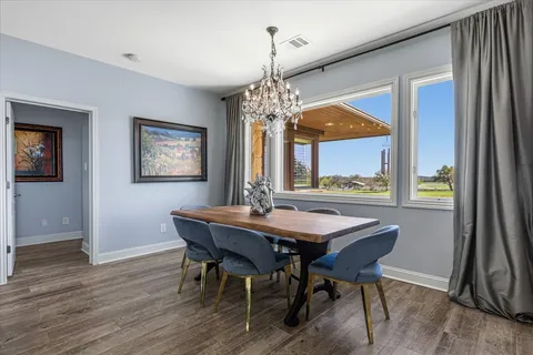 a living room with a bed furniture flat screen tv and a large window