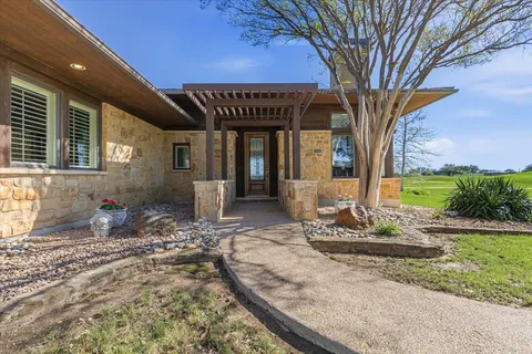 a front view of a house with yard and green space