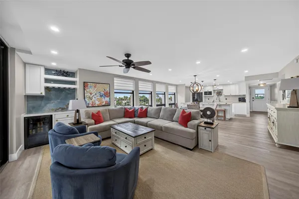 a bedroom with a bed and large windows