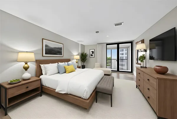 a view of a bedroom with cabinet mirror and windows