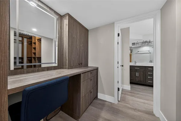 a view of walk in closet with empty racks
