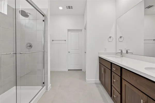 a bathroom with a sink double vanity and a mirror