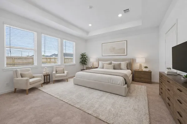 a spacious bedroom with a bed and glass windows