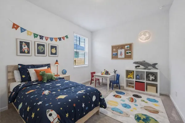 a bedroom with furniture and a window