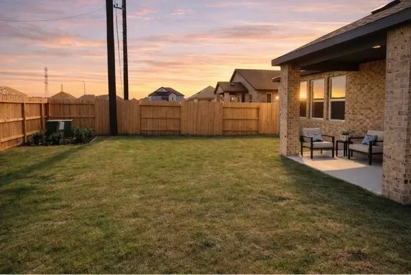 a view of a brick wall with a street
