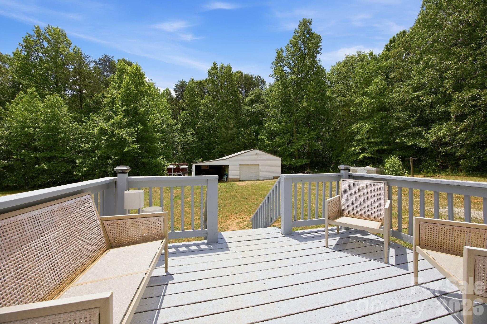 675 Overcash Road Salisbury, NC 28147 - Photo 32 of 48 a view of a deck with couches wooden floor and fence