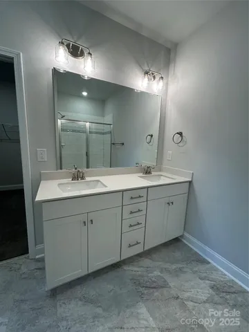 a bathroom with a double vanity sink and a mirror