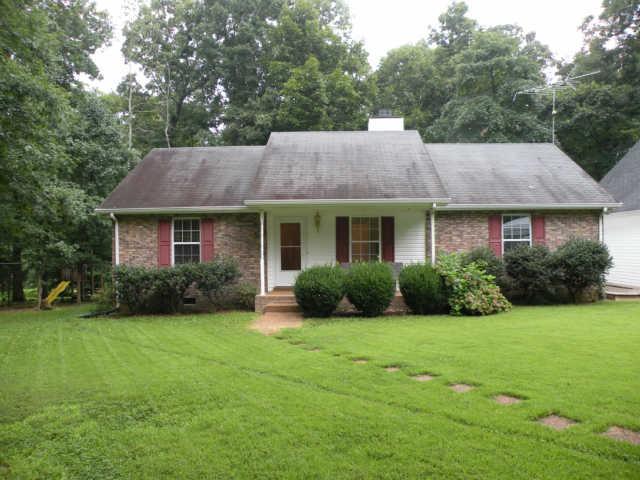 4754 Campbell Road Cross Plains, TN 37049 - Photo 1 of 20 a front view of a house with a garden and yard