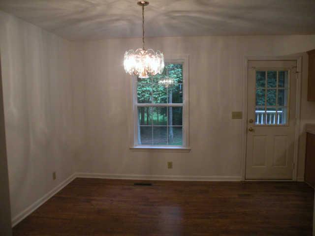 4754 Campbell Road Cross Plains, TN 37049 - Photo 12 of 20 a view of a room with wooden floor chandelier and windows