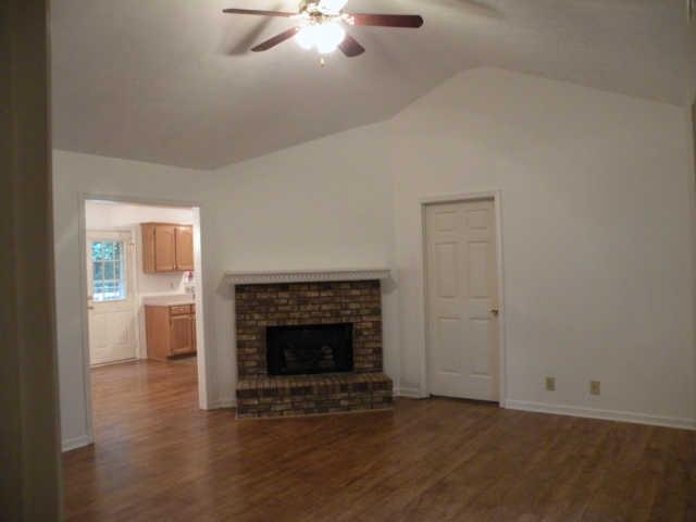 4754 Campbell Road Cross Plains, TN 37049 - Photo 7 of 20 an empty room with wooden floor a fireplace and windows