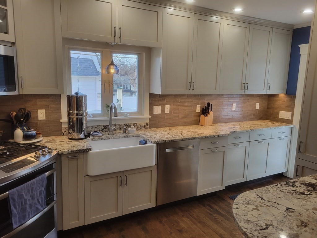970 Pleasant Street Worcester, MA 01602 - Photo 12 of 39 a kitchen with sink cabinets and window
