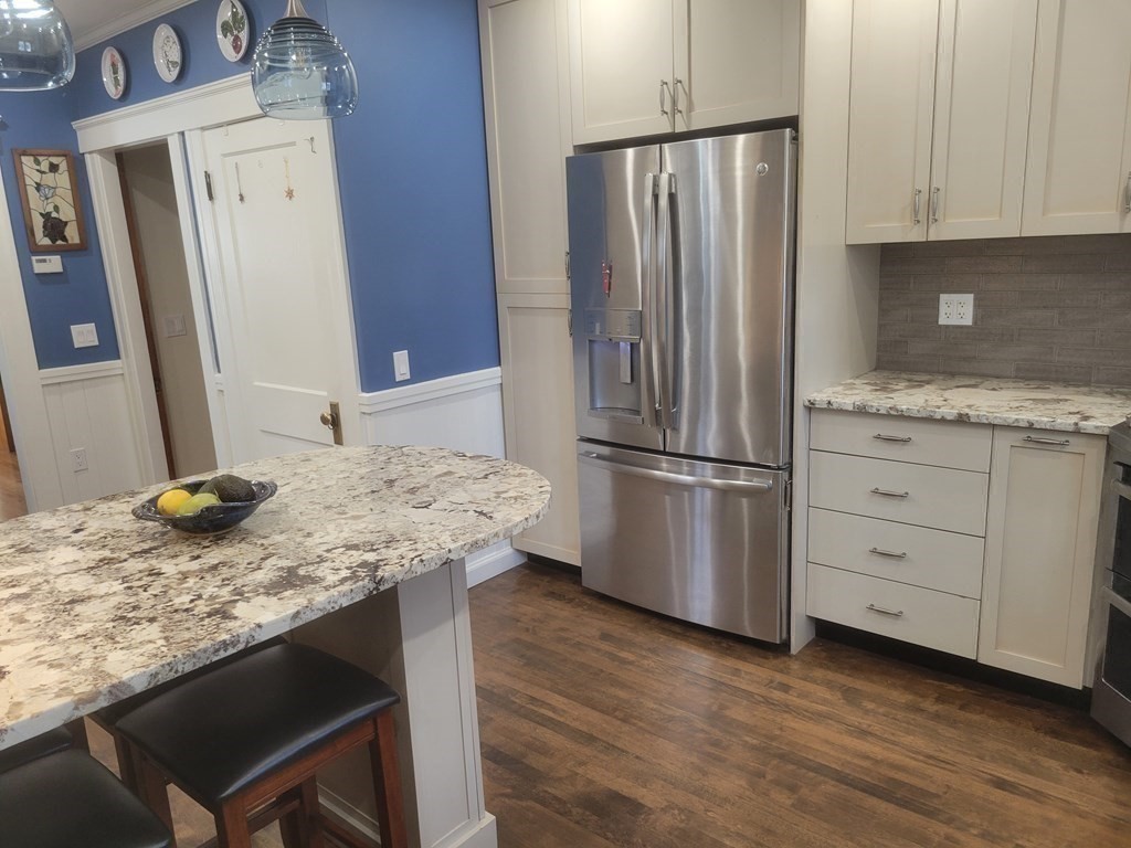970 Pleasant Street Worcester, MA 01602 - Photo 14 of 39 a kitchen with granite countertop a refrigerator and a sink