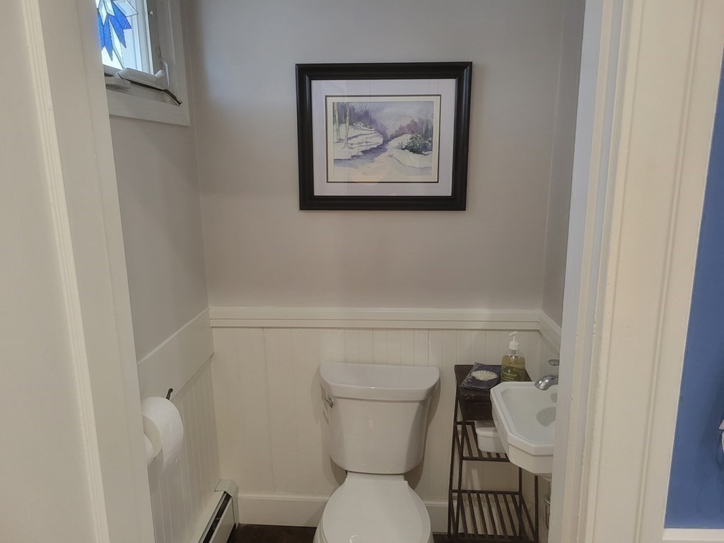 970 Pleasant Street Worcester, MA 01602 - Photo 18 of 39 a bathroom with a toilet and a picture on the wall