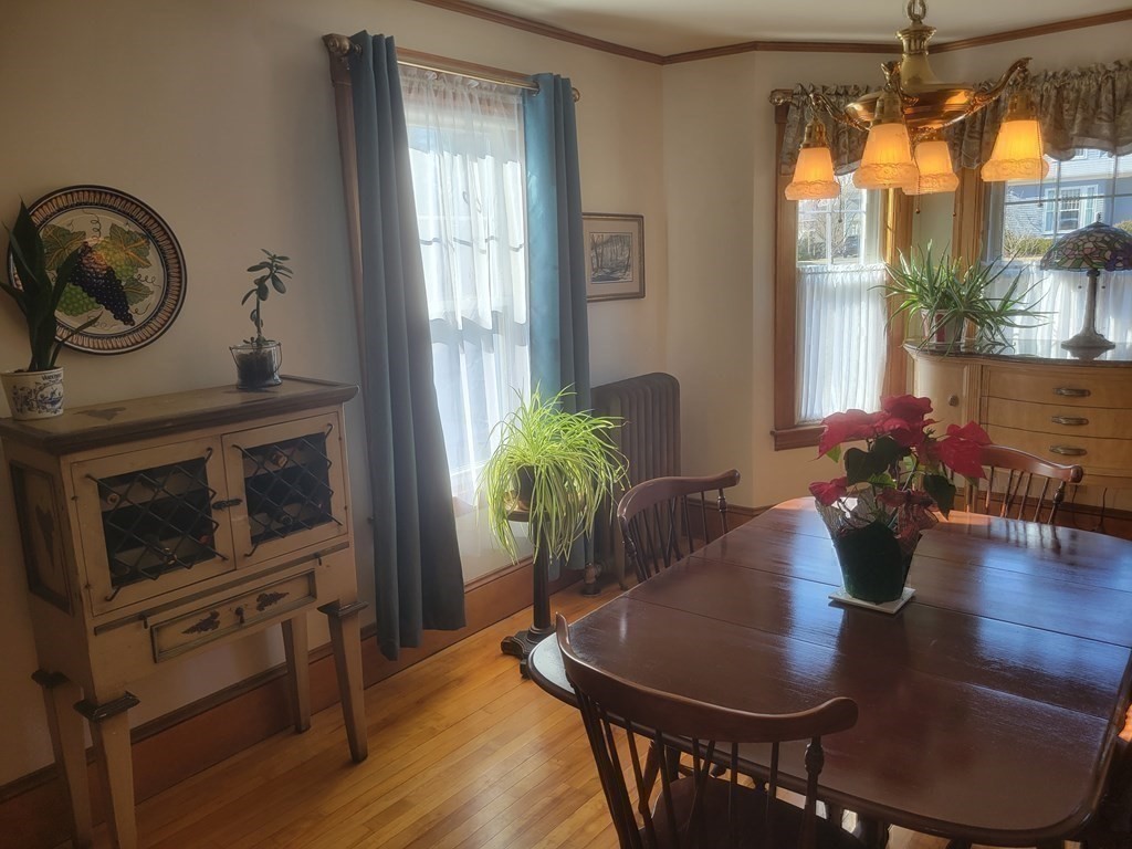 970 Pleasant Street Worcester, MA 01602 - Photo 20 of 39 a dining room with furniture potted plants and wooden floor