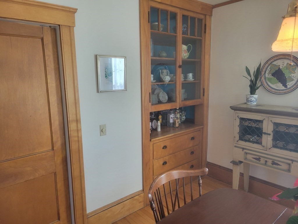 970 Pleasant Street Worcester, MA 01602 - Photo 22 of 39 a bedroom with a bed and a bookshelf with wooden floor