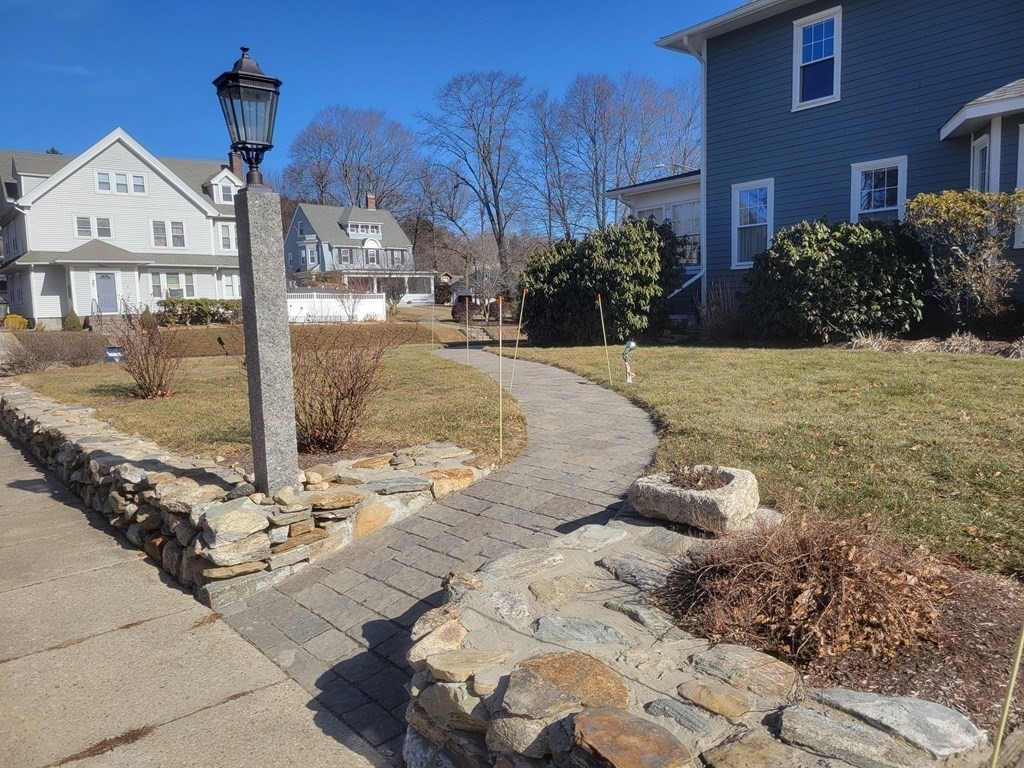 970 Pleasant Street Worcester, MA 01602 - Photo 3 of 39 a front view of a house with garden