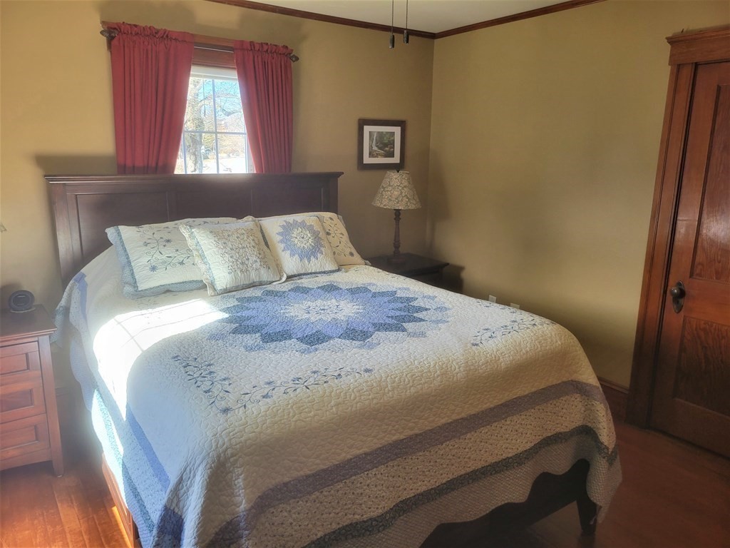 970 Pleasant Street Worcester, MA 01602 - Photo 32 of 39 a large bed sitting in a bedroom next to a window