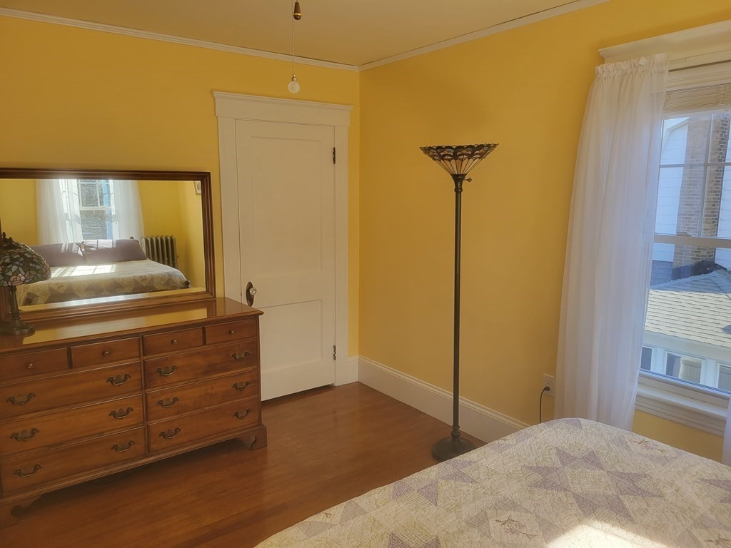 970 Pleasant Street Worcester, MA 01602 - Photo 36 of 39 a bedroom with a bed and a dresser