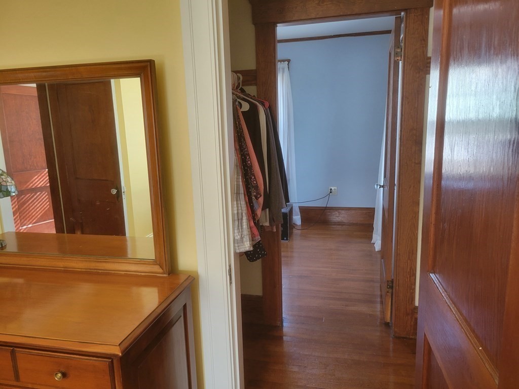 970 Pleasant Street Worcester, MA 01602 - Photo 37 of 39 a view of a hallway with wooden floor and staircase