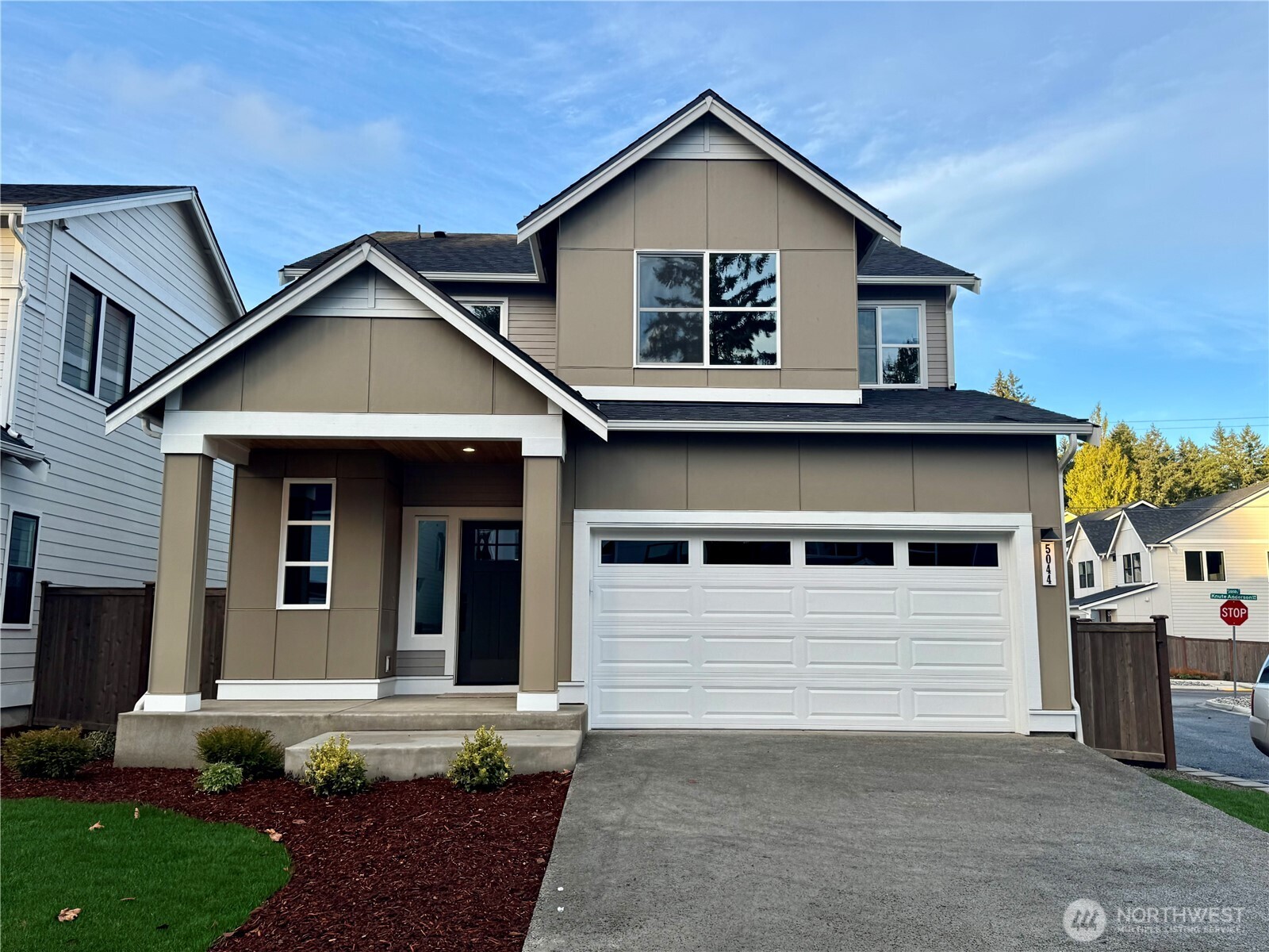 5044 Northwest Cedarside Loop Silverdale, WA 98383 - Photo 1 of 1 a front view of a house with a yard and garage