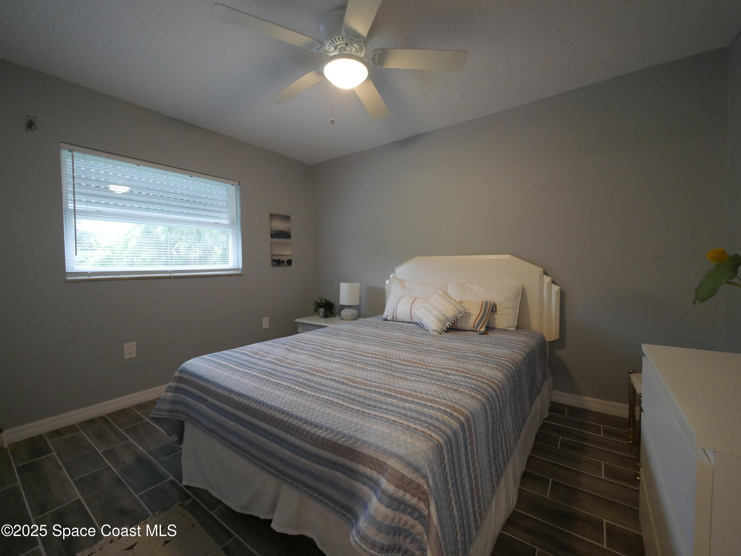 1318 South Miramar Avenue, Unit 208 Indialantic, FL 32903 - Photo 11 of 20 a bedroom with a bed and a window