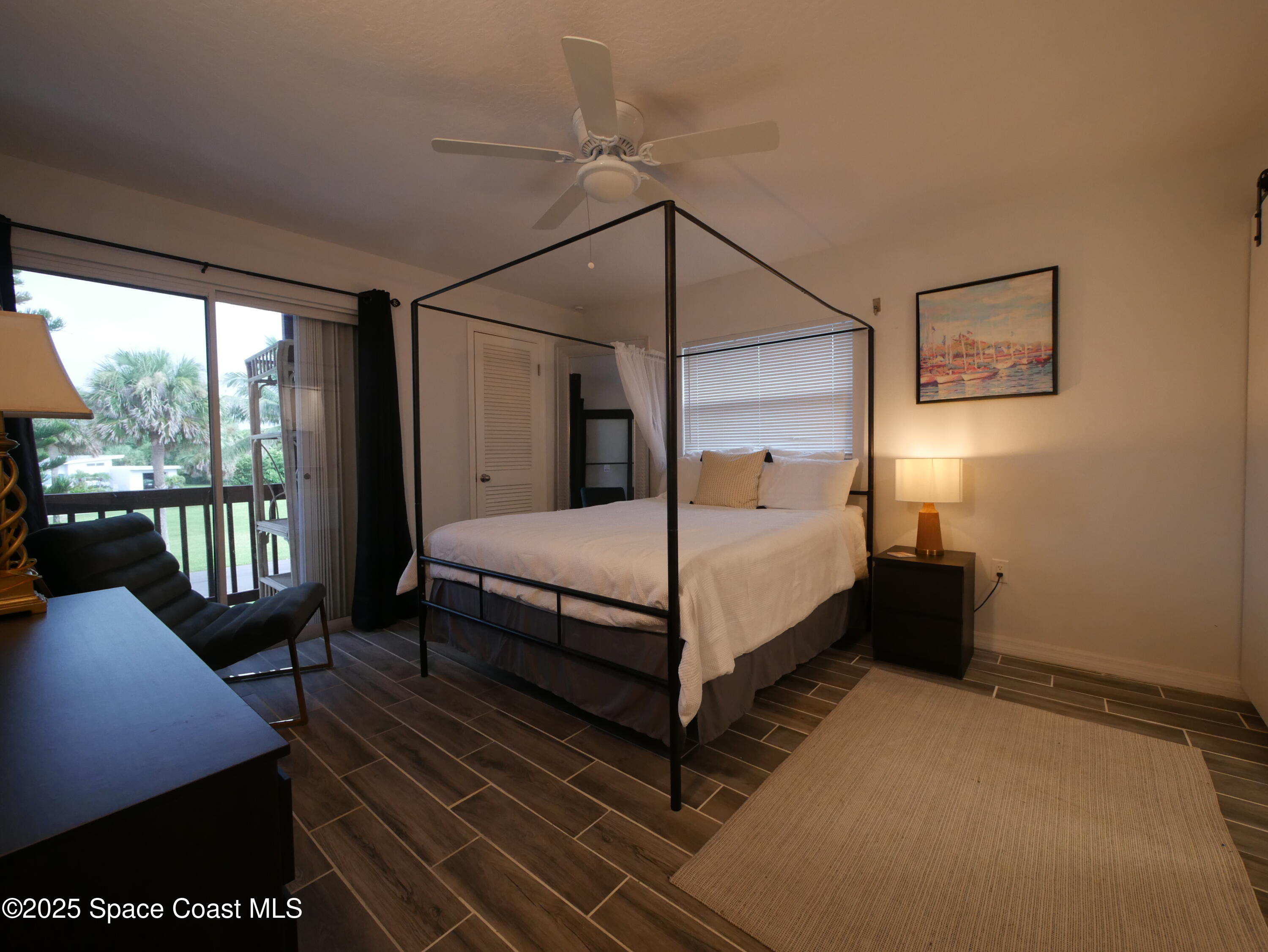 1318 South Miramar Avenue, Unit 208 Indialantic, FL 32903 - Photo 13 of 20 a bedroom with a bed lamp and window