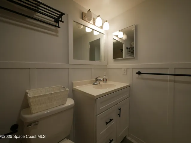 a bathroom with a sink toilet vanity and shower