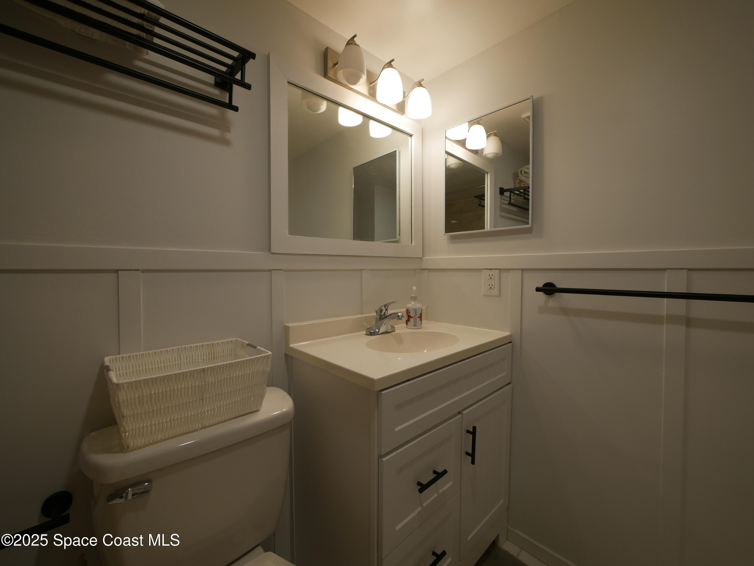 1318 South Miramar Avenue, Unit 208 Indialantic, FL 32903 - Photo 17 of 20 a bathroom with a sink toilet vanity and shower
