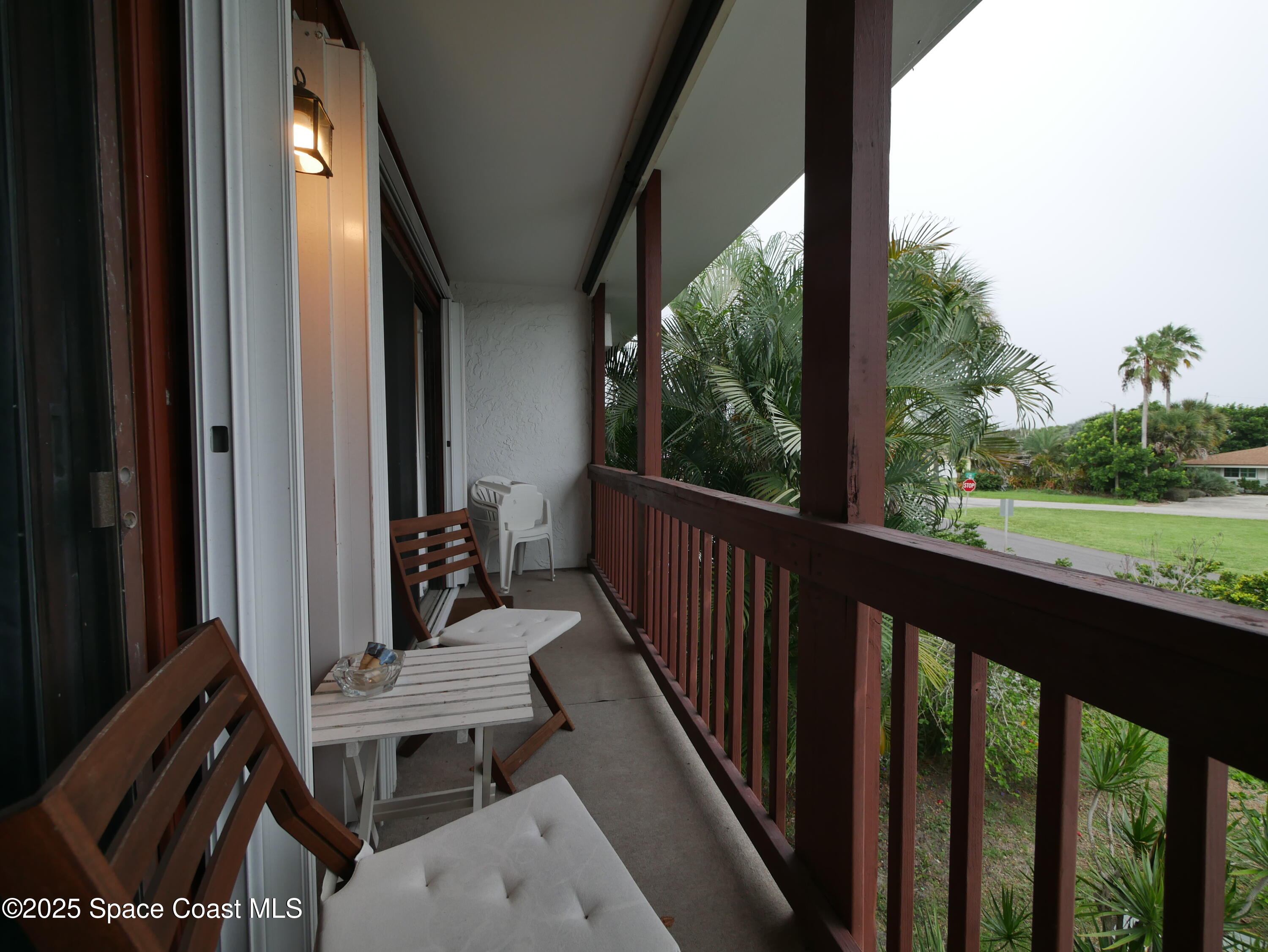 1318 South Miramar Avenue, Unit 208 Indialantic, FL 32903 - Photo 18 of 20 a view of a balcony with wooden floor