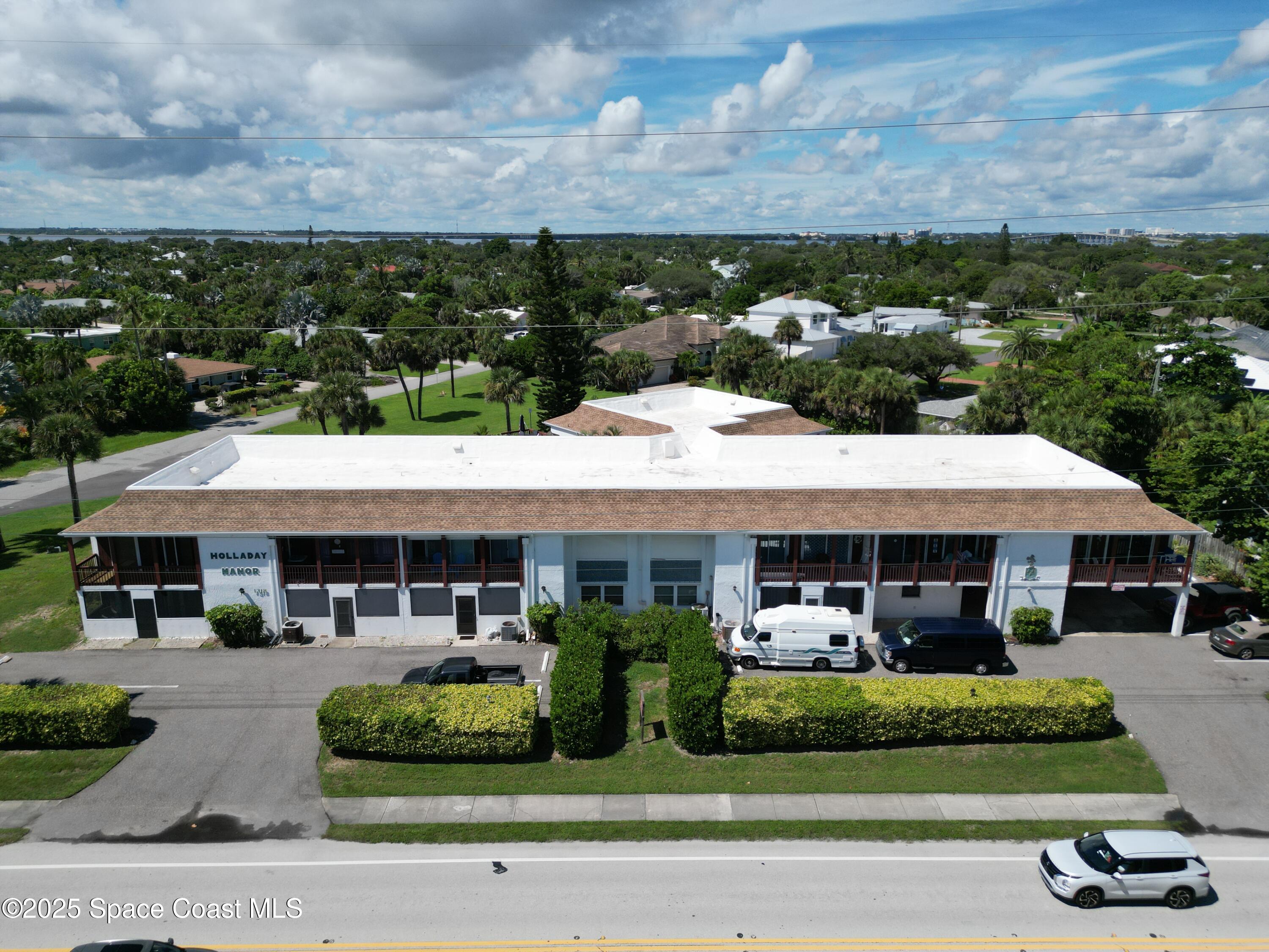 1318 South Miramar Avenue, Unit 208 Indialantic, FL 32903 - Photo 3 of 20 an aerial view of a house with a garden