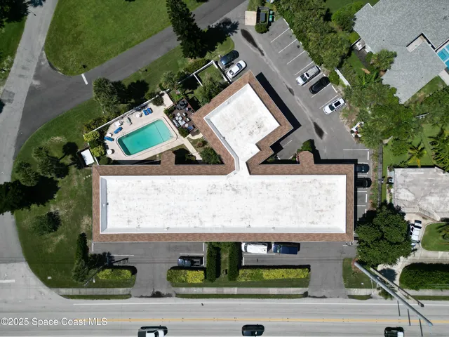 an aerial view of a house with a yard and potted plants