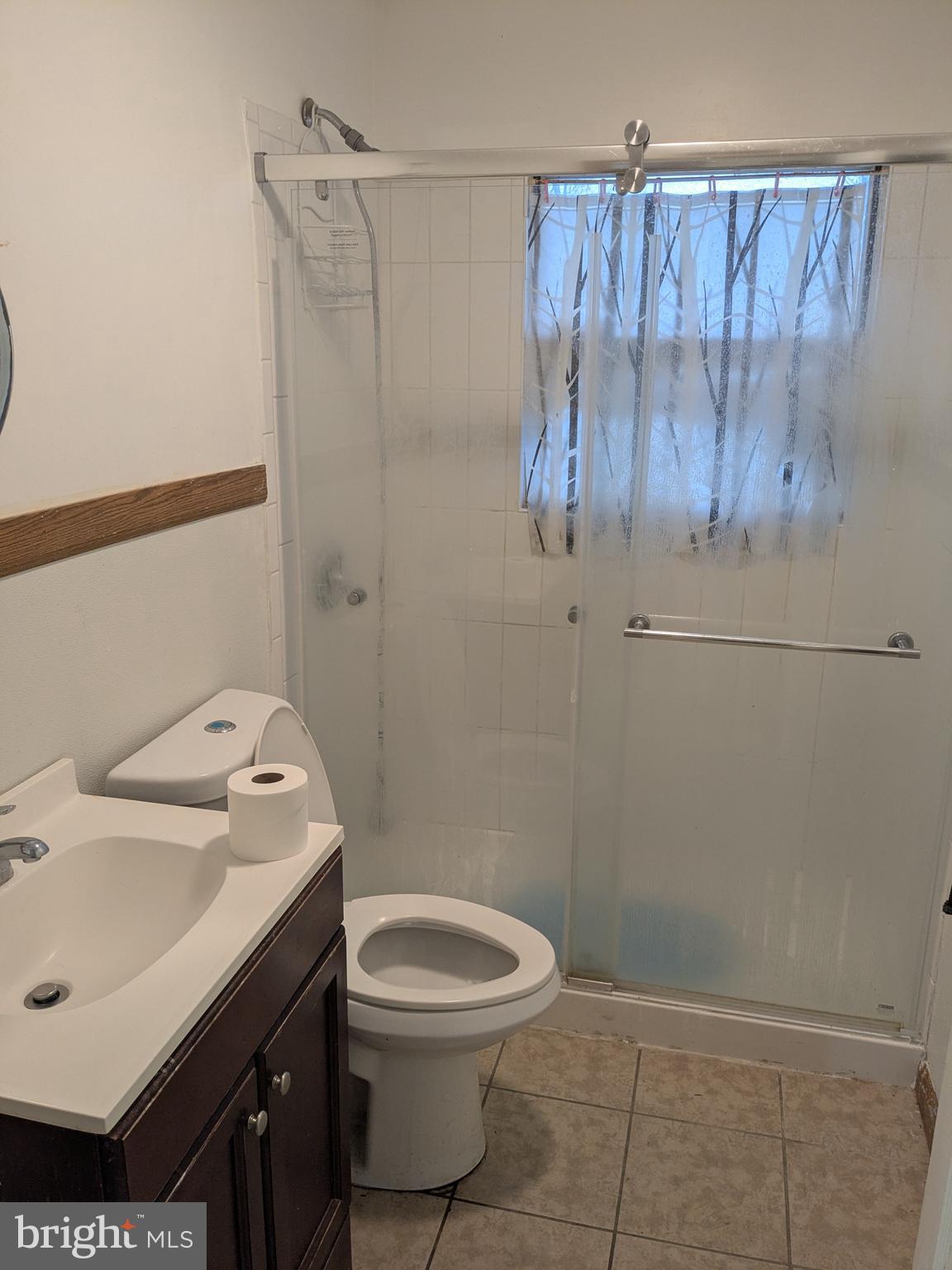 1502 3rd Avenue Bridgeton, NJ 08302 - Photo 12 of 15 a bathroom with a toilet a sink and shower