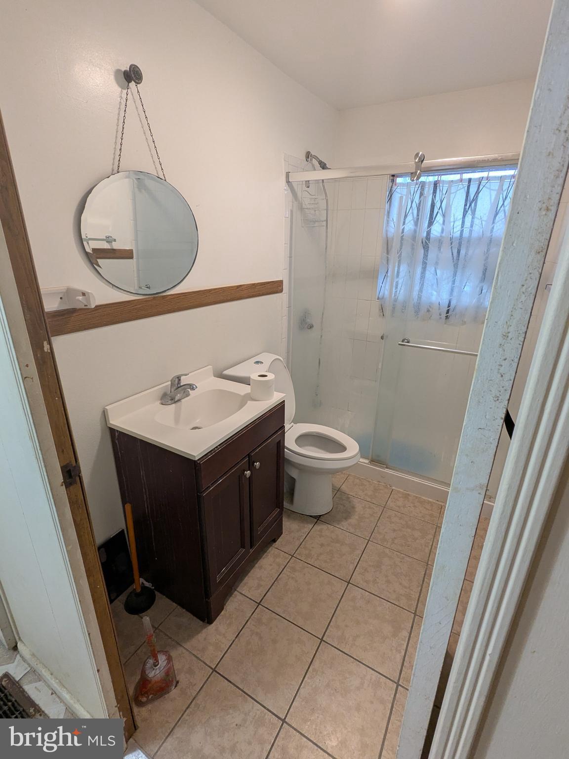 1502 3rd Avenue Bridgeton, NJ 08302 - Photo 14 of 15 a bathroom with a sink a toilet and a mirror